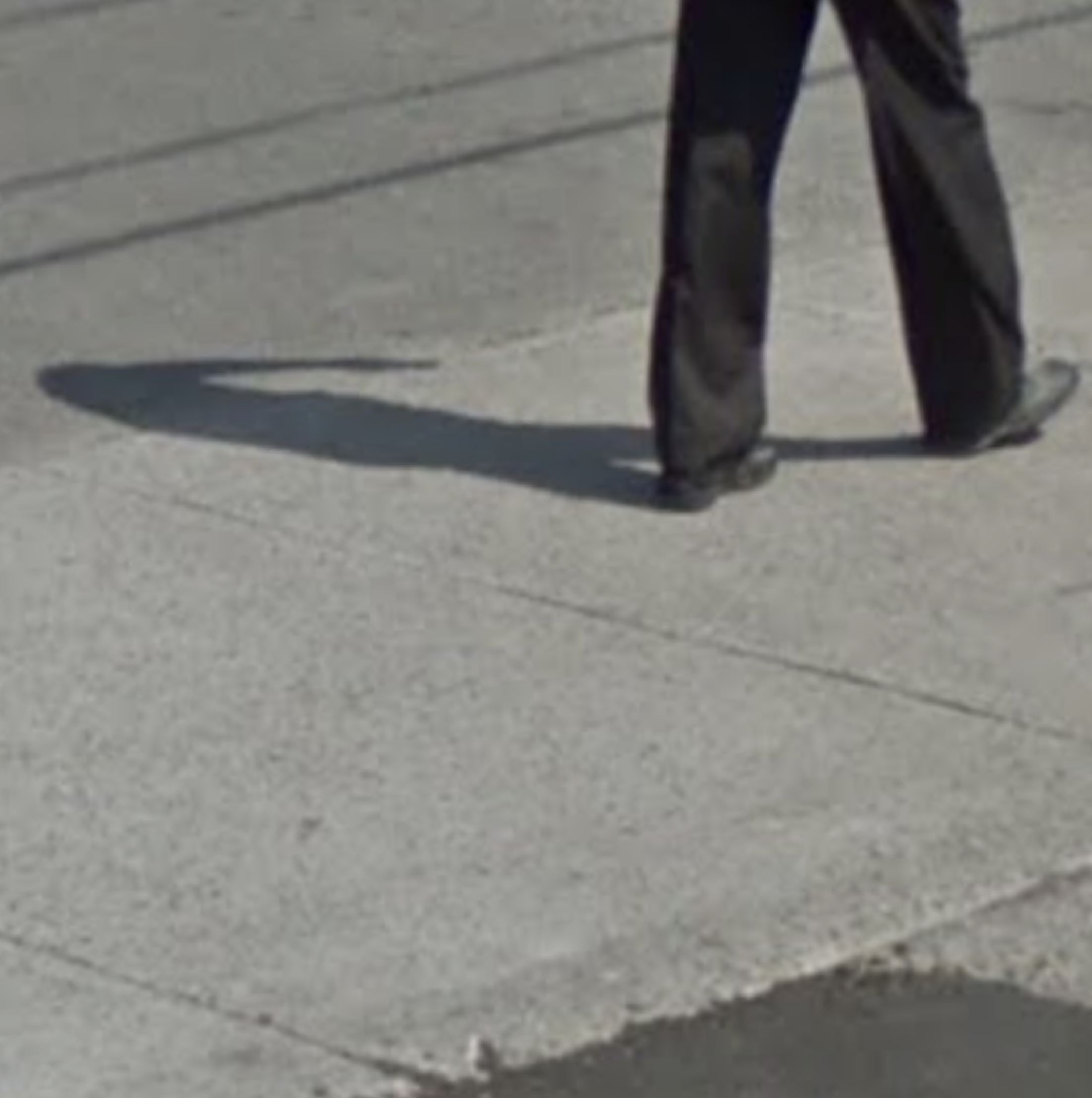 A pair of legs walking away on the sidewalk.><br><span style=
