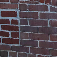 Photo of a brick wall with 'I miss you Kyle' written in chalk, taken by Anne White.